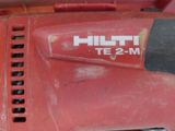 a close up of a red tool on a table