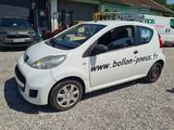 a small white car parked in front of a building