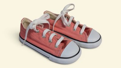 pink converse shoes with white laces on a white background