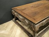 a wooden table with a wooden top on a wooden floor
