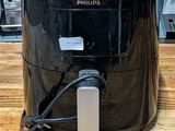 a black air fryer sitting on a wooden table