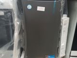 an image of a refrigerator sitting on top of a pallet next to a stack of other appliances