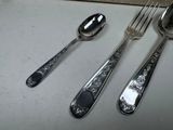 three spoons and two spoons on a table