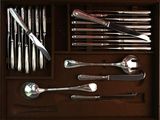 many spoons, forks and spoons in a wooden box