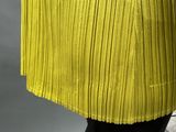 a picture of a woman wearing a yellow plea skirt