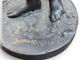 bronze statue of a child ' s feet on a round base
