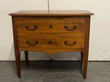 an image of a wooden chest of drawers in a room