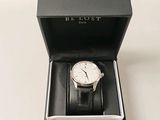 a watch in a black box on a white table
