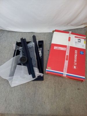 a box and a pair of scissors sitting on the floor next to a bed