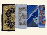 several different types of scarves are lined up on a white surface