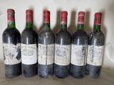 six bottles of wine are lined up in a row on a counter