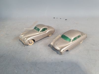 two toy cars that are sitting on a table