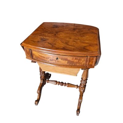 a small wooden table with a drawer on top of it