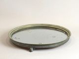 a small round mirror sitting on a white surface