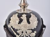 an old helmet with a bird on it sitting on top of a table