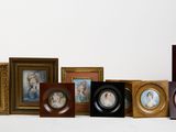 a lot of framed pictures on a white surface