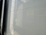 a man standing next to a white truck with its door open
