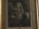 painting of a man with a horse in a gold frame on a wall
