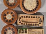 four wooden clocks and a box of matchesticks on a table