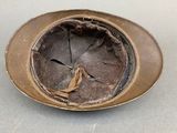 a brown hat sitting on top of a silver plate