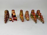 a lot of russian nesting dolls on a white surface