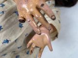 a close up of a doll ' s hand and a doll ' s hand