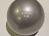 a silver ball sitting on a white surface