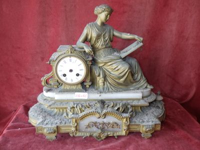 a statue of a woman sitting on top of a clock