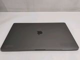 an apple macbook pro laptop computer sitting on top of a white table