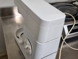 a white toaster sitting on a counter top next to a stove