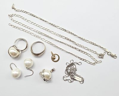 a lot of jewelry that is laying out on the table