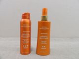 an image of two bottles of sunscreen and tanning lotion on a table