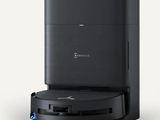 a black coffee maker sitting on top of a white surface