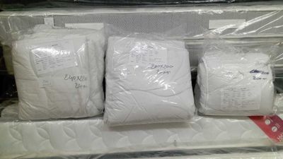 four bags of mattresses in a store display case
