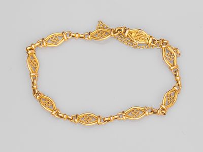 an 18k gold bracelet with an intricate design