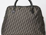 a brown and black handbag sitting on top of a white surface
