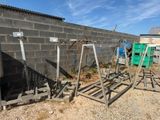 a pile of metal stands in front of a brick wall