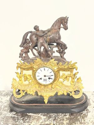 a statue of a man riding a horse on a clock