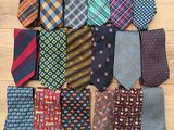 a close up of a pile of ties on a wooden surface