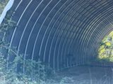 a man that is standing in the middle of a tunnel