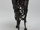 an antique black metal vase with flowers and birds on it