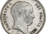 Gros plan sur une pièce de monnaie portant le visage d'un homme