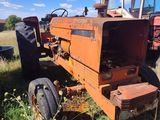a tractor that is sitting in the grass in the field