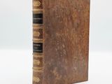 an old book with a brown cover and black binding