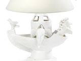a white table lamp with a white shade on top of it