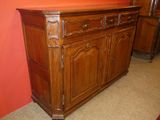 a wooden cabinet with drawers and a mirror on top of it