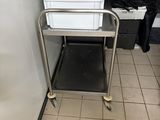 a metal cart with two plastic containers on it
