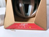 a box with a helmet inside of it on a chair