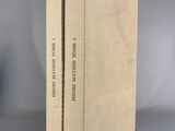 two books are stacked on top of each other on a table