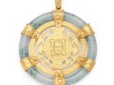 a gold and jade pendant with a medallion in the center